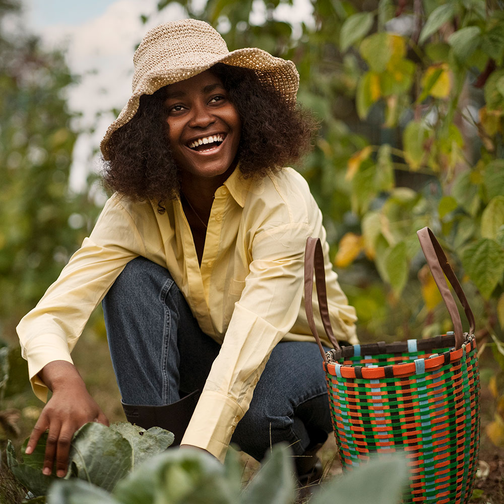 About Us full shot smiley woman working outdoors