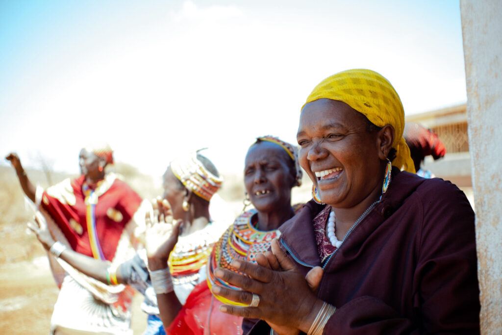Our Funds kenya lms member of karare milk cooperative clapping in joy marsabit county